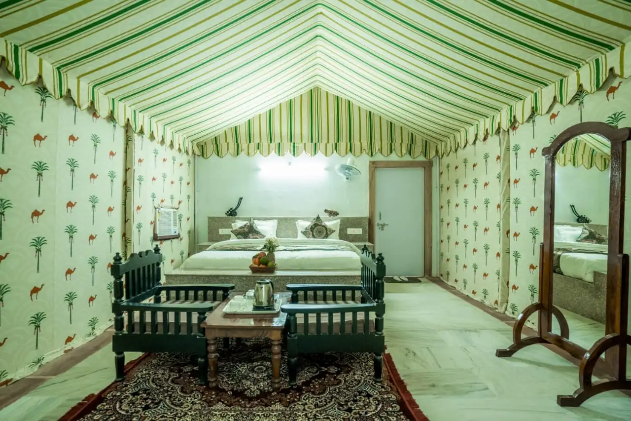 Maharaja Luxury AC Tent interior with bed and traditional seating