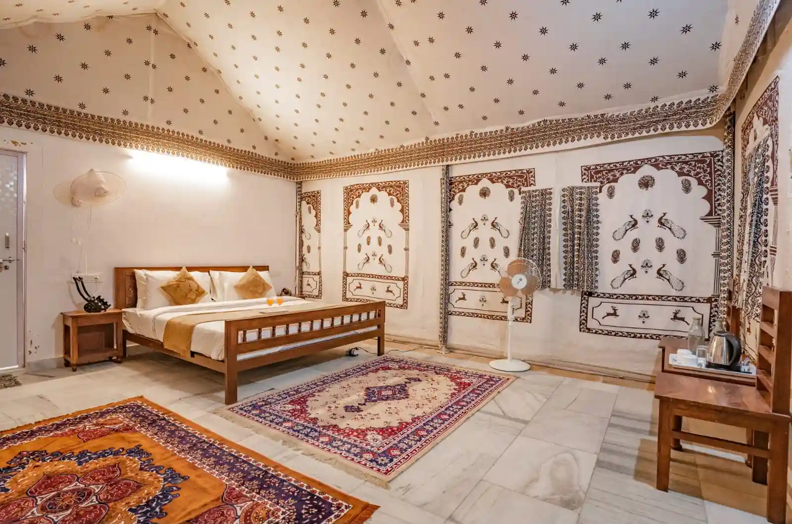 Royal Swiss Luxury Tent interior with traditional Rajasthani wall art