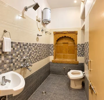 Clean attached bathroom with traditional carved wooden alcove