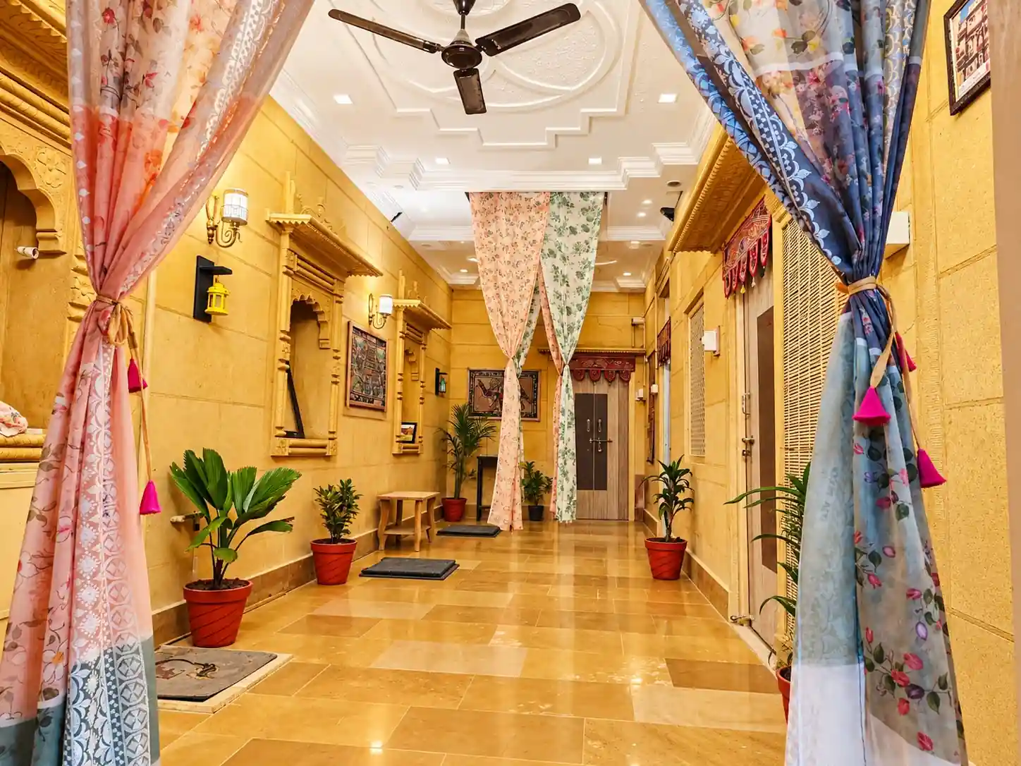 Traditional Rajasthani corridor with carved archways at Heritage Haveli Jaisalmer